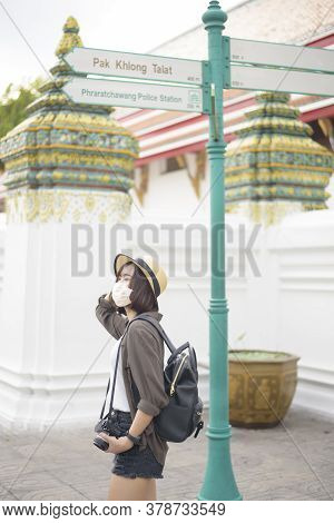 A Young Pretty Asian Woman Is Wearing Protective Mask Travelling Around Famous Places In Bangkok Cit