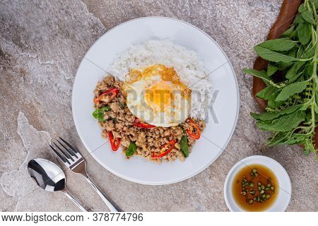 rice topped with stir-fried mince pork and basil with fried egg , Thai famous Street food