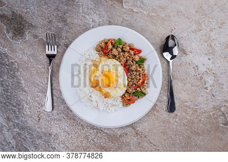 rice topped with stir-fried mince pork and basil with fried egg , Thai famous Street food