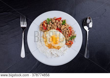 rice topped with stir-fried mince pork and basil with fried egg , Thai famous Street food