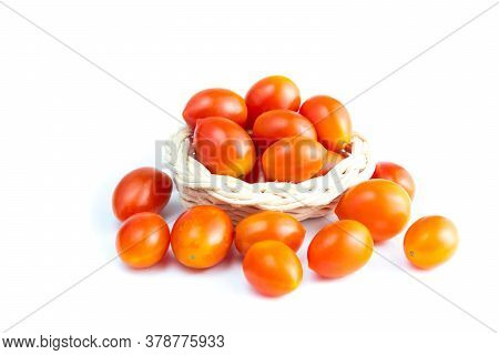 Cherry Tomatoes In A Basket. (solanum Lycopersicum L. Var. Cerasiforme). Isolated On White Backgroun