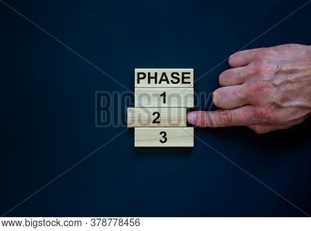 Wooden Blocks Form The Words 'phase, 1, 2, 3,' On Black Background. Male Hand. Beautiful Background.