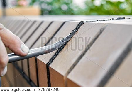 Bricklayer Builds New Fence From Facing Bricks. Alignment Of Inter-brick Joints
