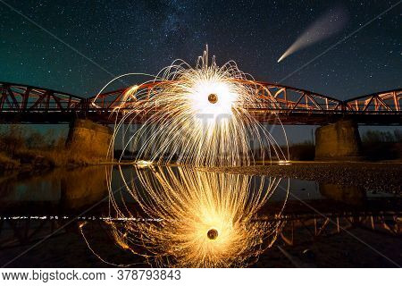 Spinning Steel Wool In Abstract Circle, Firework Showers Of Bright Yellow Sparks On Long Bridge Refl
