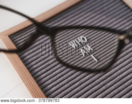 Top View On Letterboard With Words Who Am I Through Eyeglasses. Flat Lay Concept Of Psychological Se