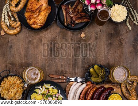 Oktoberfest Dishes: Beer, Pretzel, Sausage, Stewed Cabbage, Potato Salad Half Of Chicken And Ribs