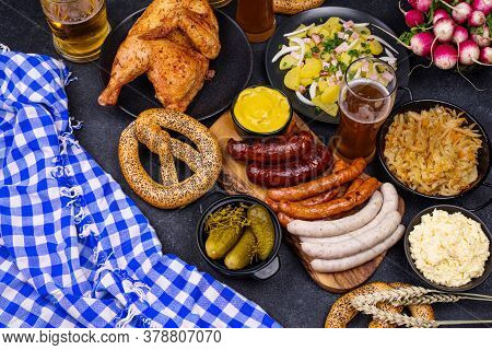 Oktoberfest Dishes: Beer, Pretzel, Sausage, Stewed Cabbage, Potato Salad Half Of Chicken And Ribs