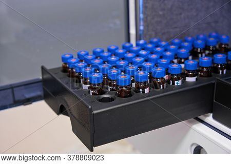 Glass Vials With Blue Caps Are In The Rack Of Hplc System With Autosampler. Separation Of Compounds 