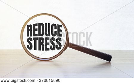 Magnifying Glass With Text Reduce Stress On Wooden Table.