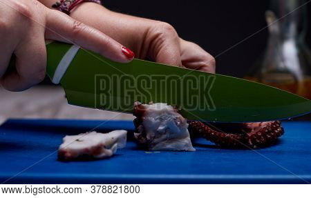 Night Photography Of A Plate Of Octopus And Oil With Salad