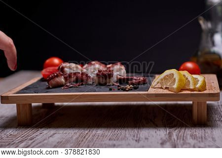 Night Photography Of A Plate Of Octopus And Oil With Salad