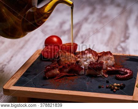 Night Photography Of A Plate Of Octopus And Oil With Salad