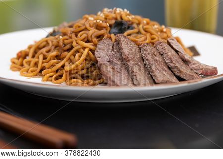 Korean Traditional Jajjangmyeon Black Bean Instant Noodles On A Plate.