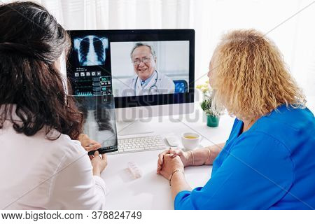 General Practitioner And Senior Patient Having Telemedicine Session With Pulmonologist