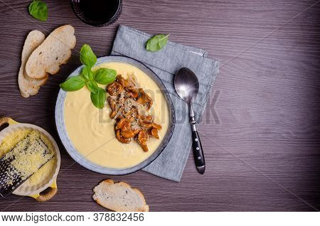 Traditional Polenta With Mushrooms And Cheese In A Dish On A Dark Wooden Background. Selective Focus