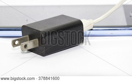White-black Smartphone Mobile Phone Charging Cable On A White Background. Taken In The Studio With L