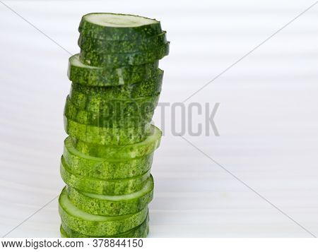 Fresh Raw Sliced Cucumber In White Background- Organic And Healthy Vegetable.