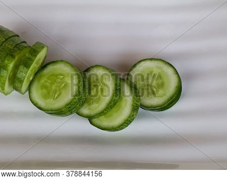 Fresh Raw Sliced Cucumber In White Background- Organic And Healthy Vegetable.