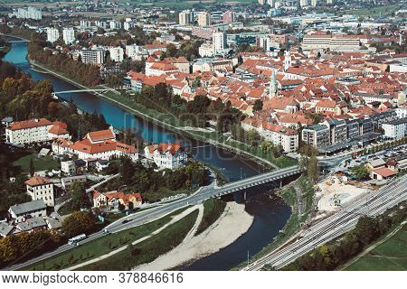 Aerial View To The City Celje In Slovenia. Red Roofs, River And The Bridge. Outdoor Travel Backgroun