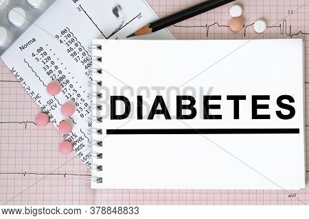 Notebook Page With Text Diabetes On A Table With A Pills And Pencil, Medical Concept, Top View