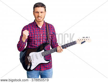 Handsome young man with bear playing electric guitar annoyed and frustrated shouting with anger, yelling crazy with anger and hand raised 