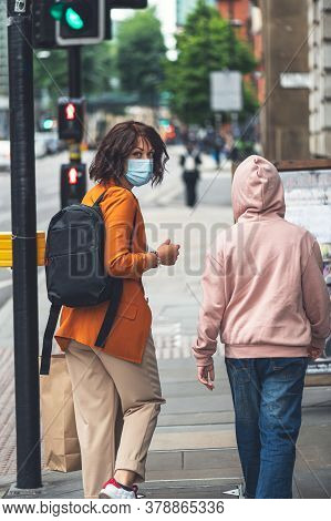 Mum And Daughter In Face Mask Are Shopping In City Centre Of Manchester, England, Uk , New Normal