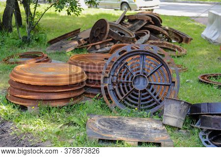 Road Works .old Rusty Metal Sewer Manholes For Underground Communications On The Grass. Next To The 