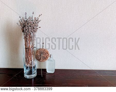 A Lavender Glass Vase And A Decorative Bead Accentuate The Frosted Perfume Bottle, Creating An Inter