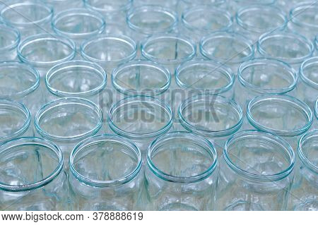 Transparent Empty Glass Bottles In A Bottling Plant, On A Production Line In A Factory Or For Sale I