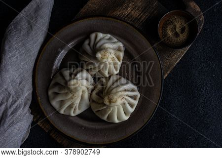 Traditional Georgian Khinkali Dish On Stone Background