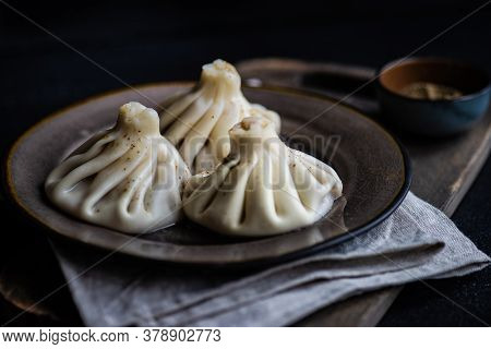 Traditional Georgian Khinkali Dish On Stone Background