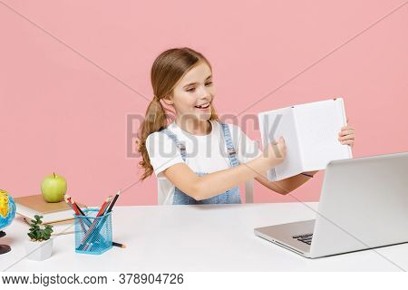 Cheerful Little Kid Schoolgirl 12-13 Years Old Sit Study At Desk Isolated On Pink Background. School