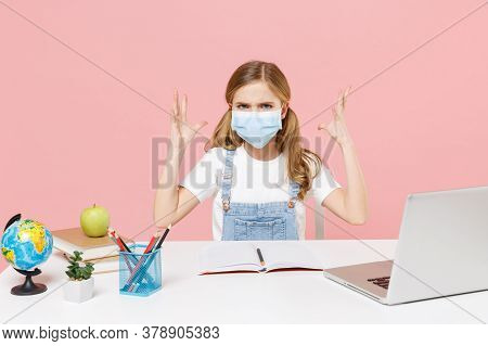 Displeased Little Kid Schoolgirl 12-13 Years Old In Face Mask Study At Desk With Pc Laptop Isolated 
