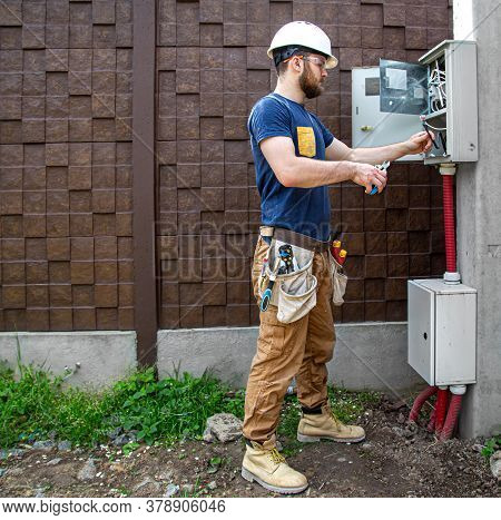 Electrician Builder At Work, Examines The Cable Connection In The Electrical Line In The Fuselage Of