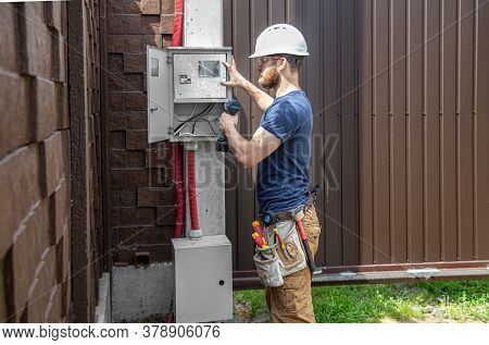 Electrician Builder At Work, Examines The Cable Connection In The Electrical Line In The Fuselage Of