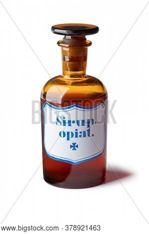 Historic old pharmacy bottle with opium syrup isolated on white background