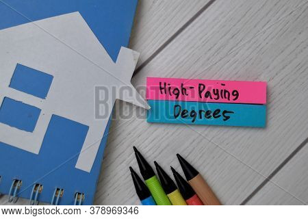 High-paying Degress Text Write On Sticky Notes Isolated On Office Desk.