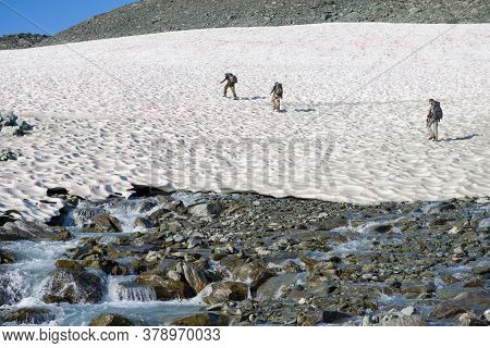 Yamal, Russia - August 26, 2018: Tourists Climb The Pink Snow In The Vicinity Of The Igan Glacier. P