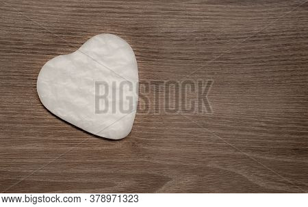 White Heart Shape Paper Cutted For Surprise Valentines Day Present On Brown Wooden Background, Top V