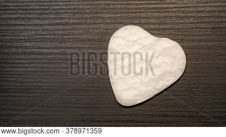 White Heart Shape Paper Cutted For Surprise Valentines Day Present On Black Wooden Background, Top V