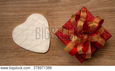 Red Gift Box With Golden Ribbon And White Heart Paper Cut For Surprise Valentines Day Present On Bro