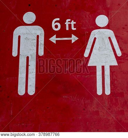 Red Sign On The Floor That Informs People To Keep 6 Ft A Social Distance.the Figures Of A Man And A 
