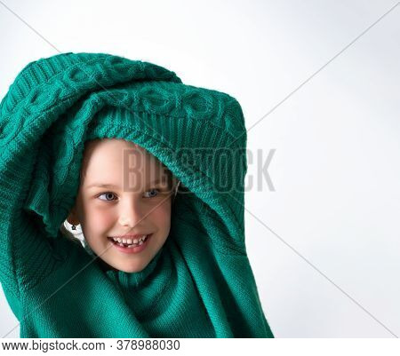 Playful Little Girl Wearing Knitted Green Sweater That Is Too Big For Her And Raising Hands In Long 