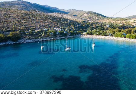Aerial view of sail boats in front of Aliki beach at Thassos island, Greece. Amazing beach with a turquoise and transparent sea.