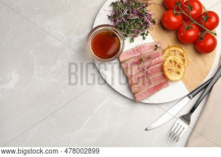 Pieces Of Delicious Tuna Steak Served On Light Grey Marble Table, Flat Lay. Space For Text
