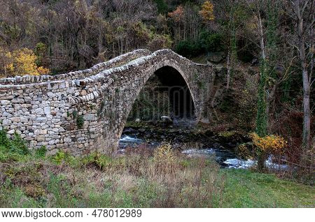 Landscape View Of Pont De La Margineda Stone Arch Bridge Over River La Valira At Sunset Near Andorra