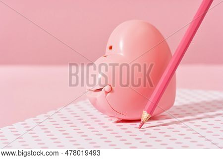 Pink Pencil Tip Touching Desk On Polka Dot Pink Background With Diary Or Copybook. Office Or School 