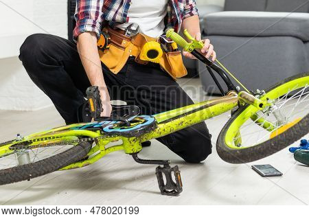 Bicycle Mechanic Adjusting Front Derailleur Mechanism On Mountain Bike