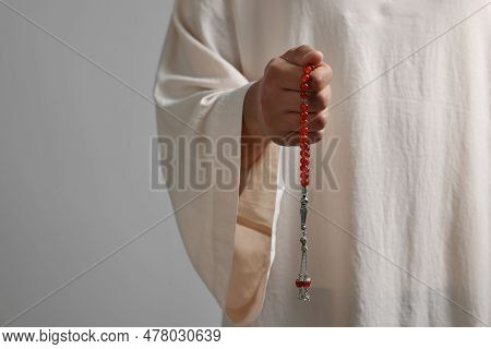 Muslim Woman With Misbaha On Light Grey Background, Closeup. Space For Text