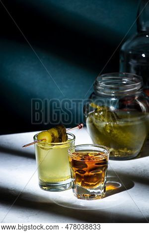 Pickleback, Alcoholic Cocktail Drink From Cucumber Pickle And Whiskey In Small Shot Glasses. Hard Li